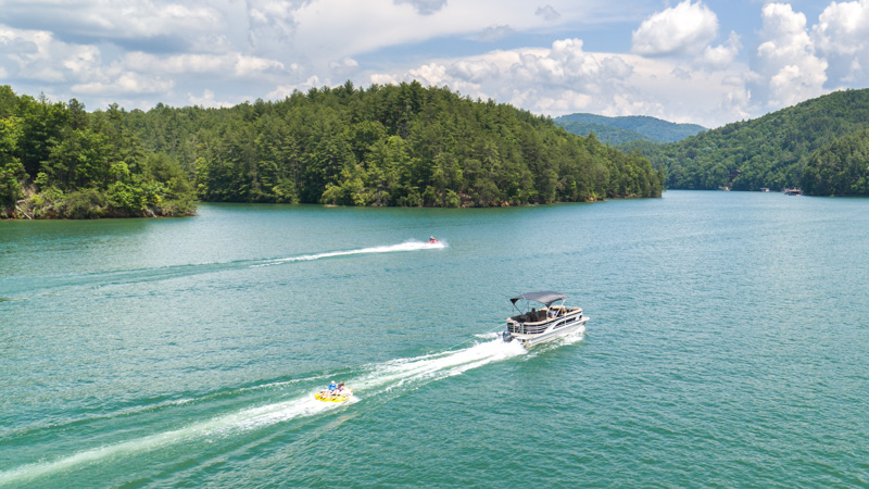 Pontoon boat cruising on Lake Blue Ridge with mountain views in North Georgia