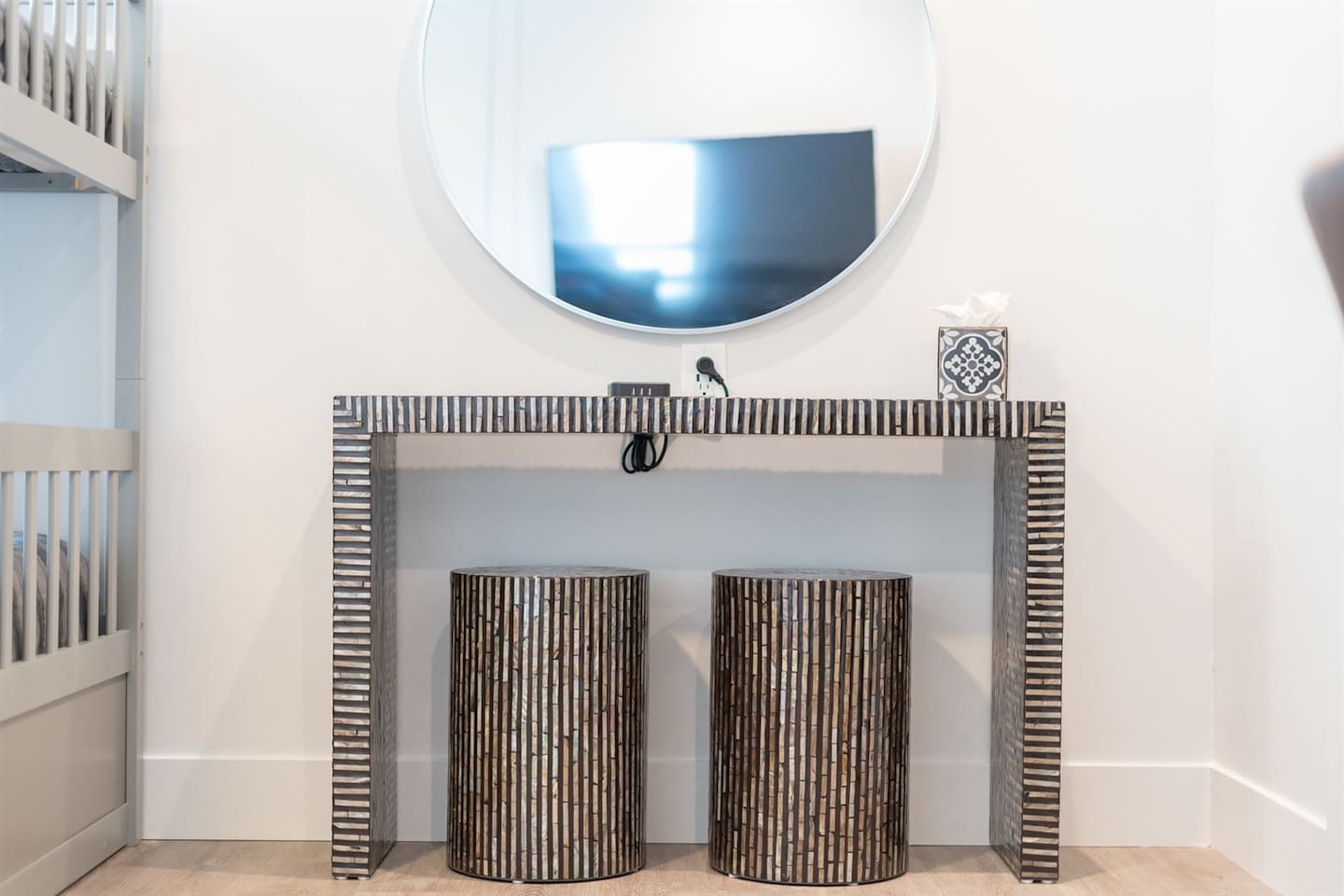 Enhance your routine at the stylish vanity area, complete with a comfortable stool chair and a large mirror, providing the perfect space for getting ready in style.