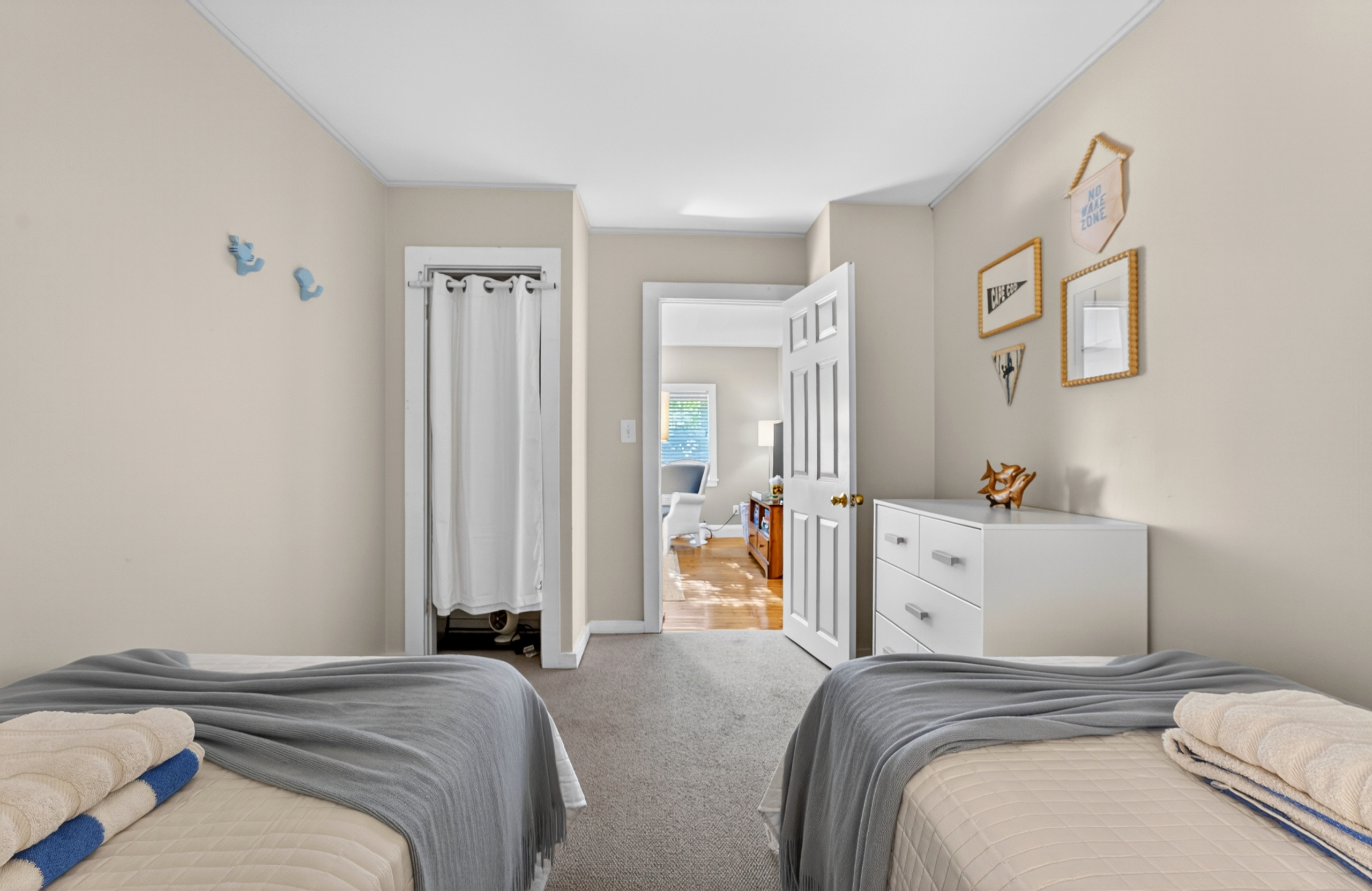 A comfortable bedroom with 2 single beds suitable for those traveling with kids.