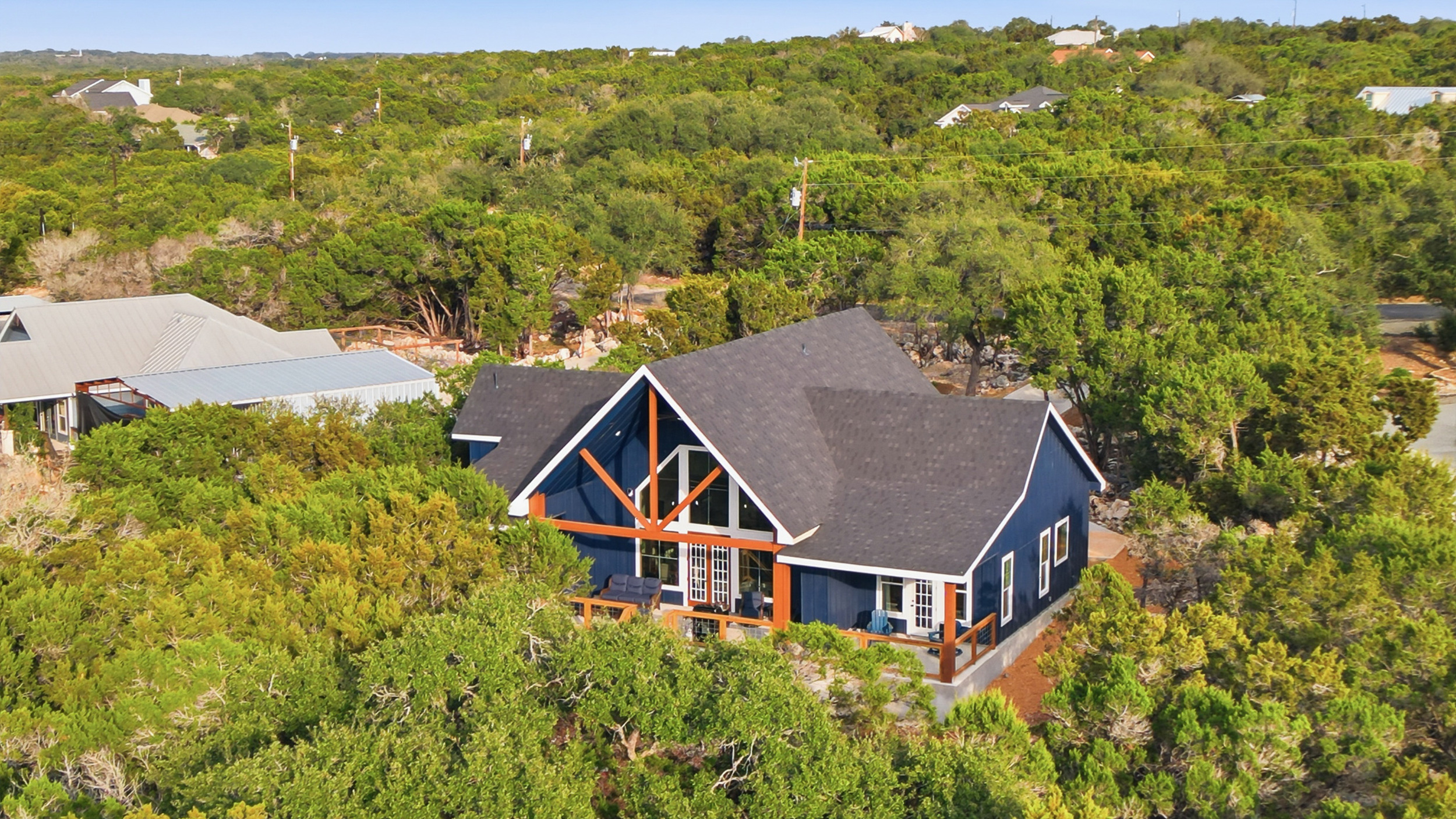 Dragonfly Ridge Estate surrounded by mature trees, offering privacy and space between Canyon Lake and Gruene.