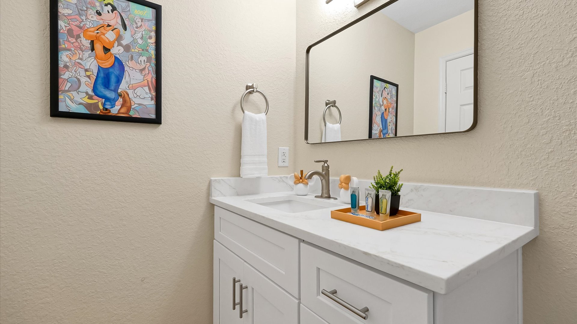 Mickey’s Rainbow Magic Bathroom – Bright vanity with generous counter space and character artwork