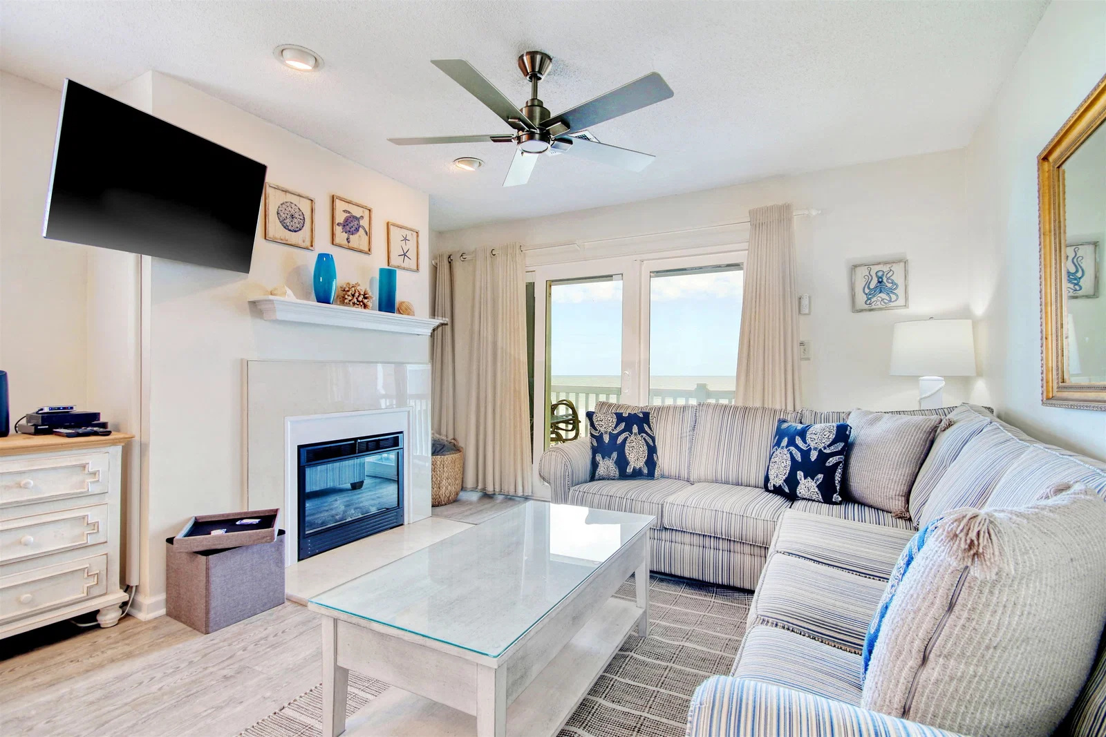Living room with sectional sofa, electric fireplace and wall-mounted TV