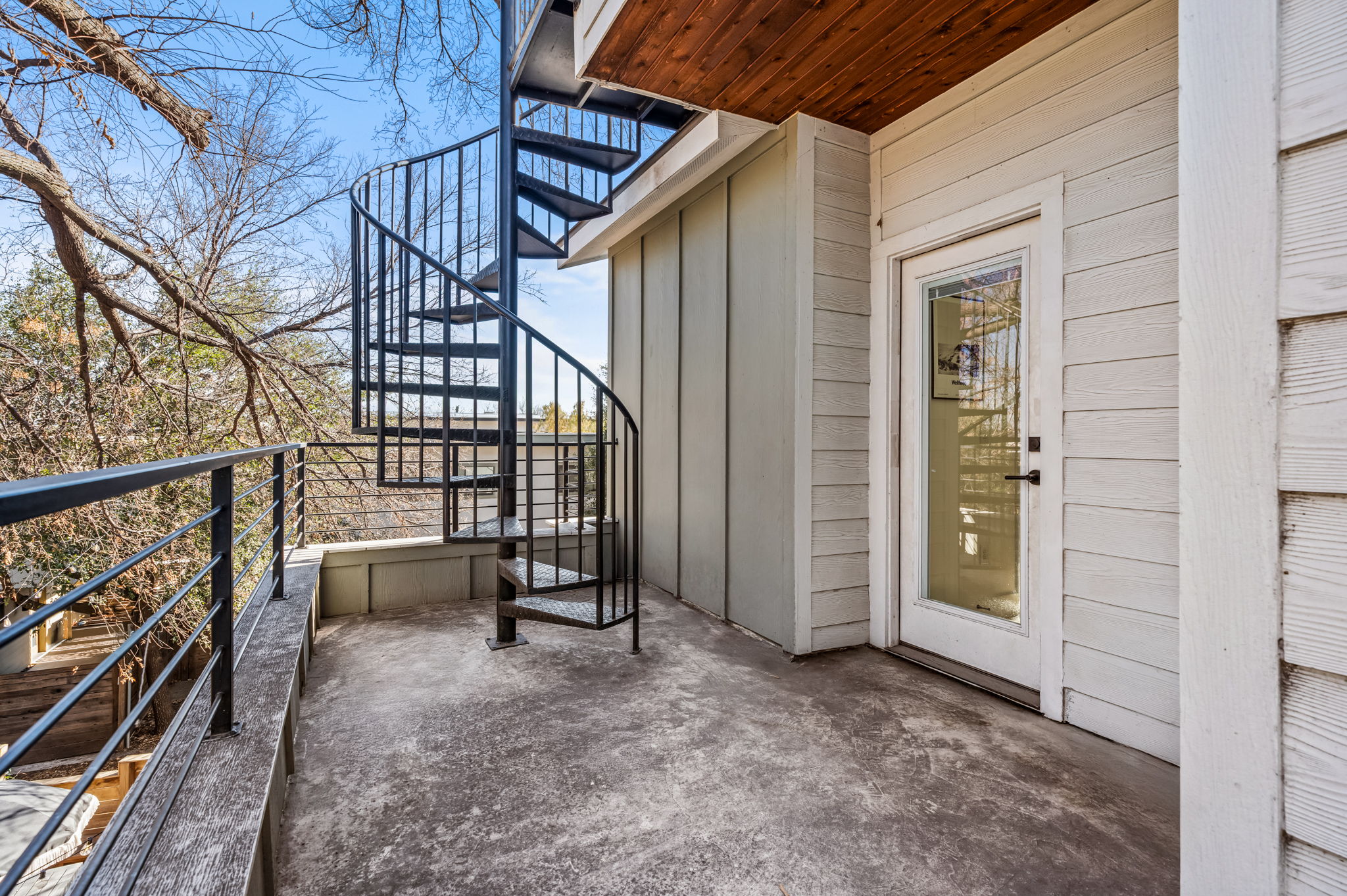 Elevated terrace with spiral staircase and peaceful outdoor space