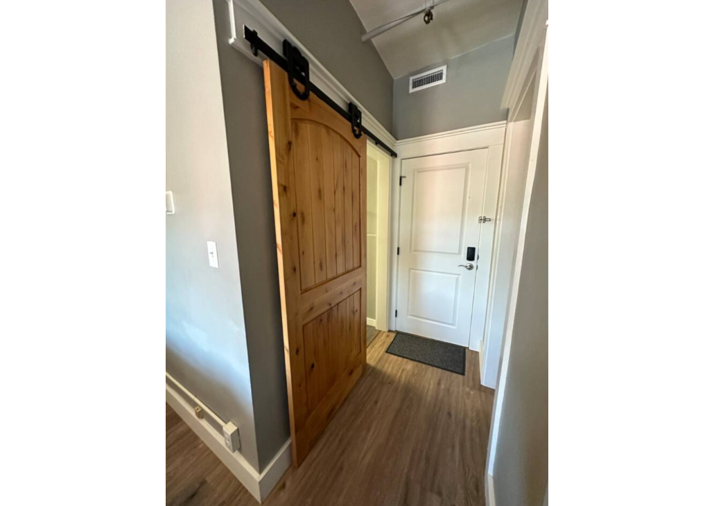 Bathroom barn door to the left and the closet on the right.