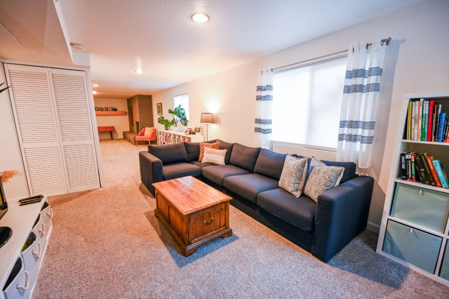 Downstairs living room with television, DVD player, books, and games