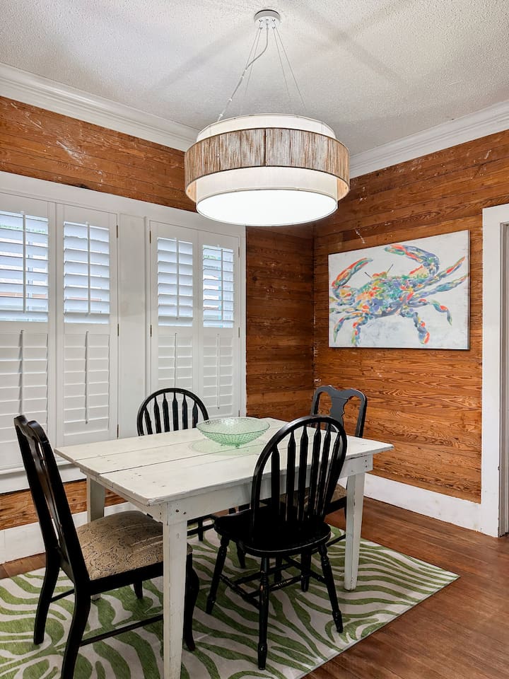 A table for 4 makes a cozy dining space with natural wood accents, bright light, and a welcoming setup for everyday dining.