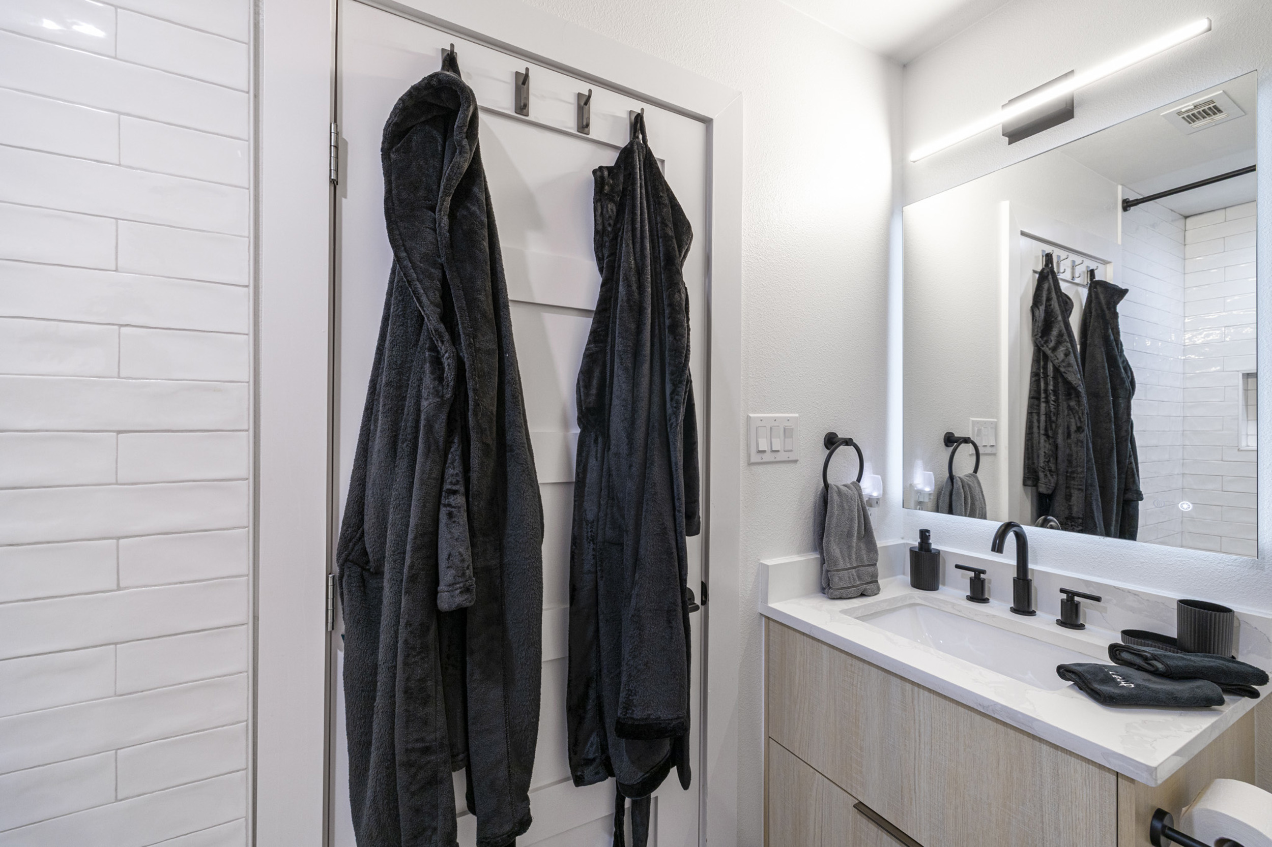 tylish space with sleek finishes and plush robes for ultimate relaxation!