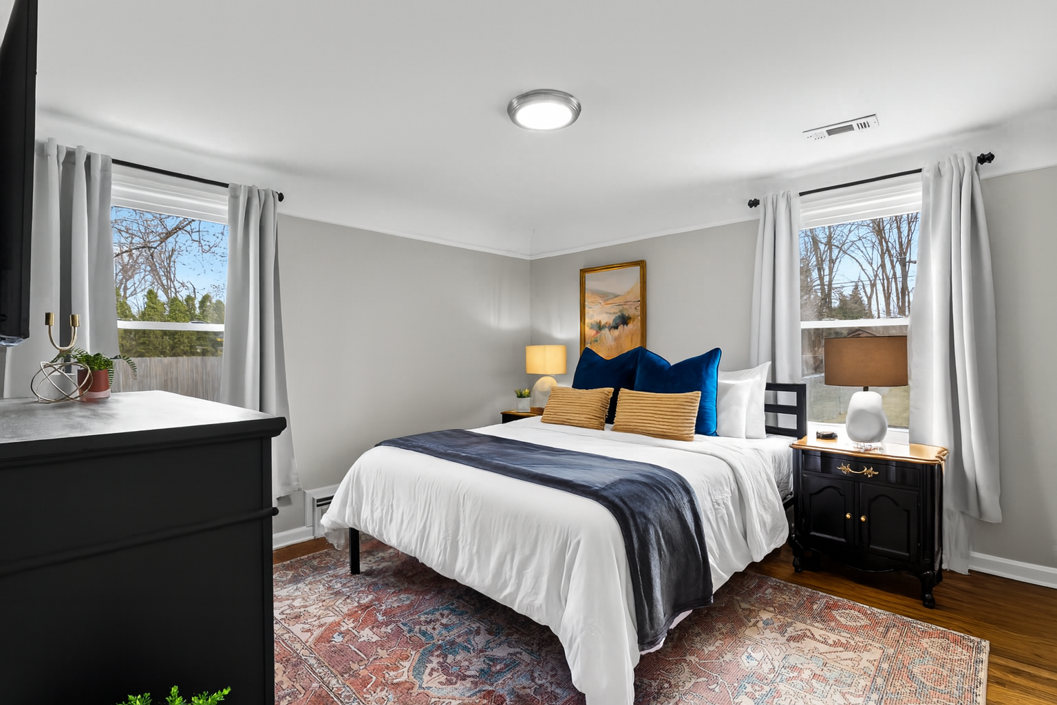 Bright & spacious bedroom offers both natural light and black out curtains