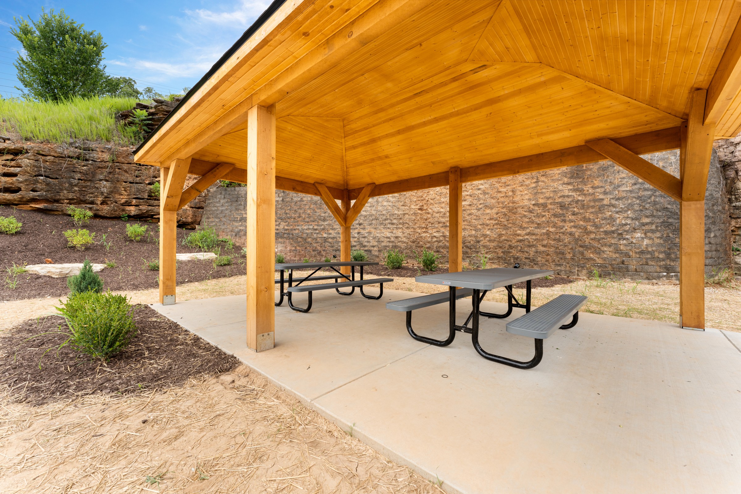 Covered community picnic pavilion by the rock bluff. Shade, tables and fresh air for an easy outdoor meal.