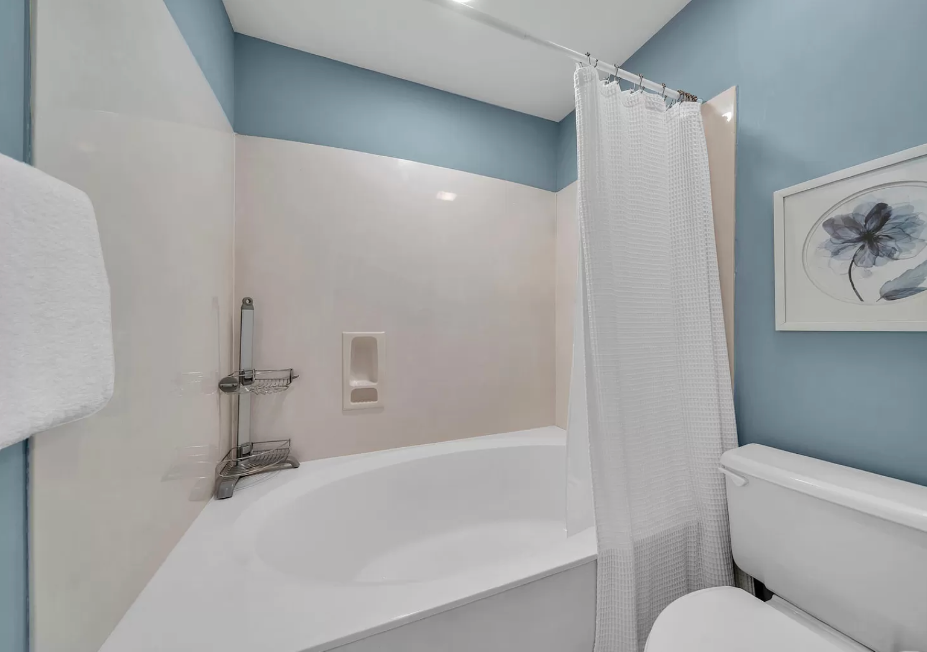 Bright bathroom with renovated bathtub and shower.