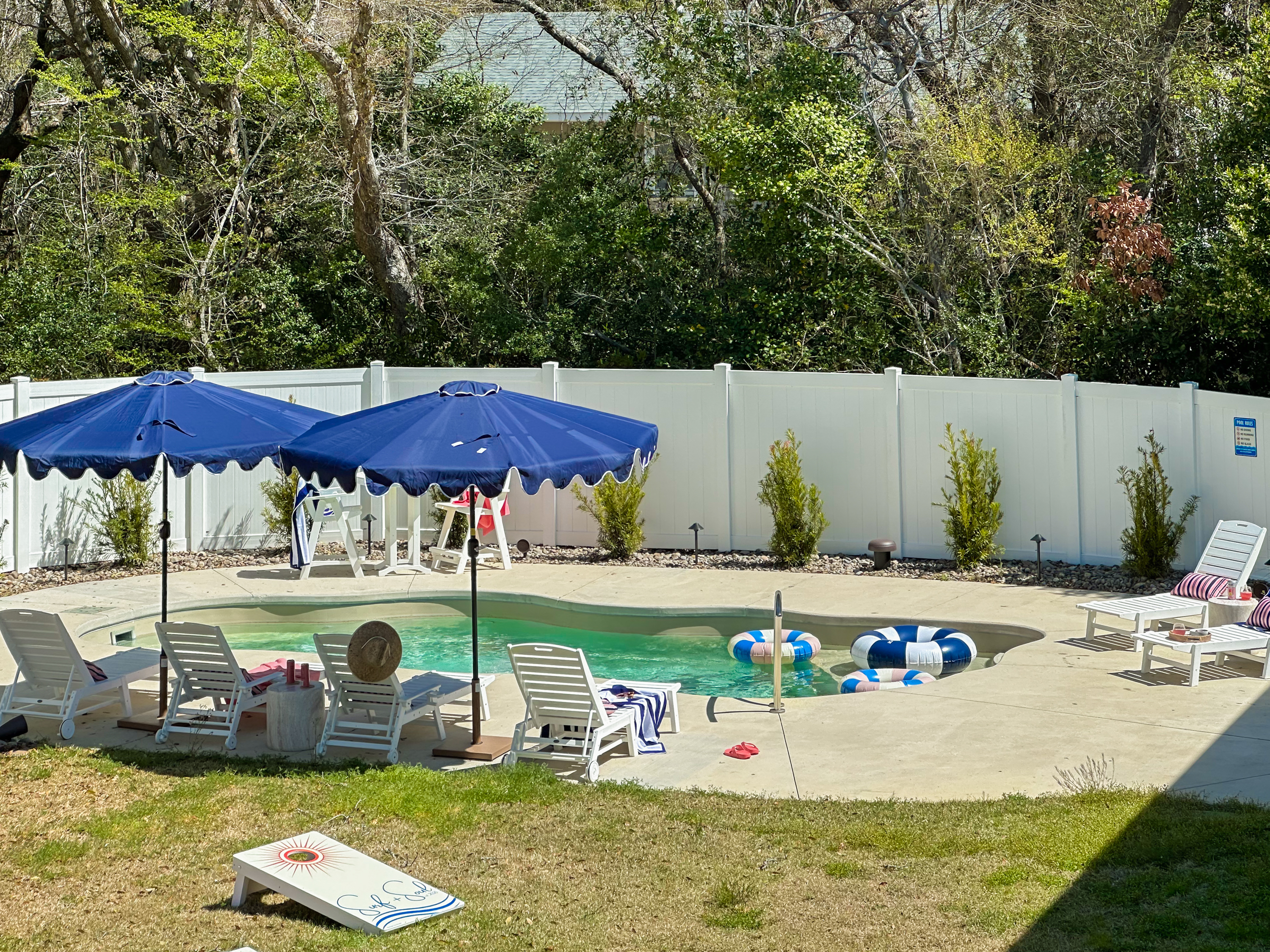 The backyard oasis continues to the private pool.