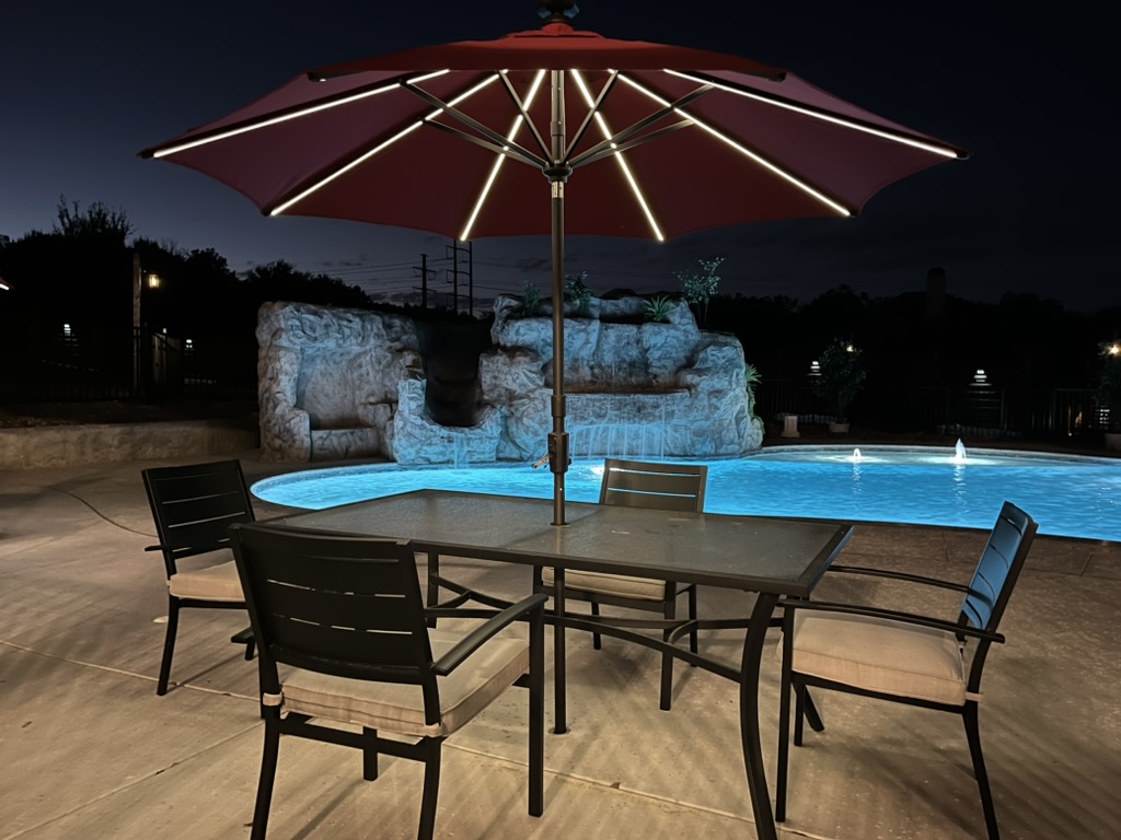 Light-up umbrellas provide nice relaxing lighting for evening pool-side chats