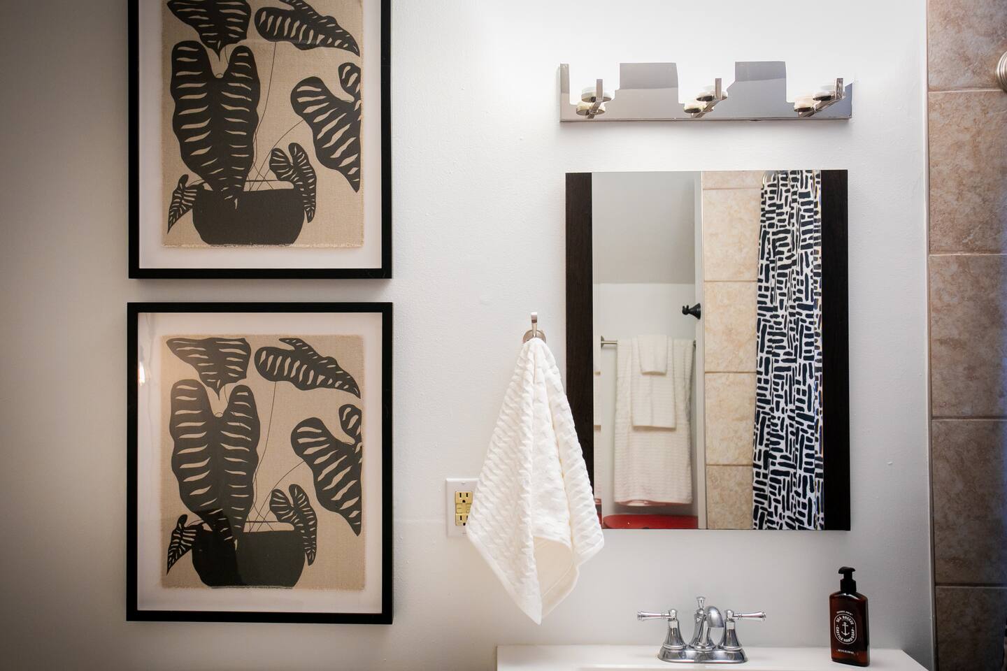 Thoughtful lighting, clean lines, and subtle artwork create a calm, put-together space for daily routines.