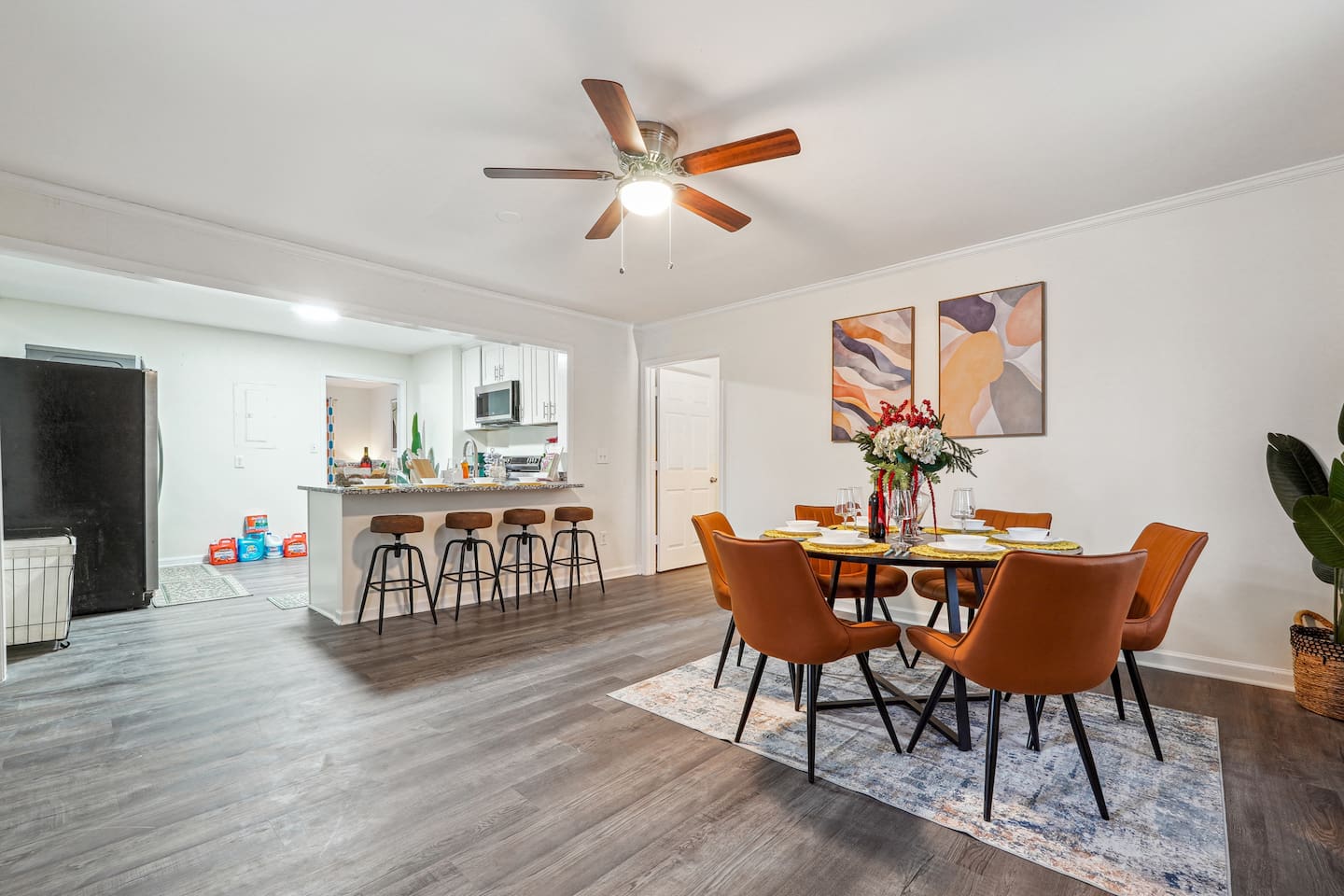 A dining area featuring a dining table set and a bar counter with four bar chairs — perfect for enjoying meals or casual drinks.
