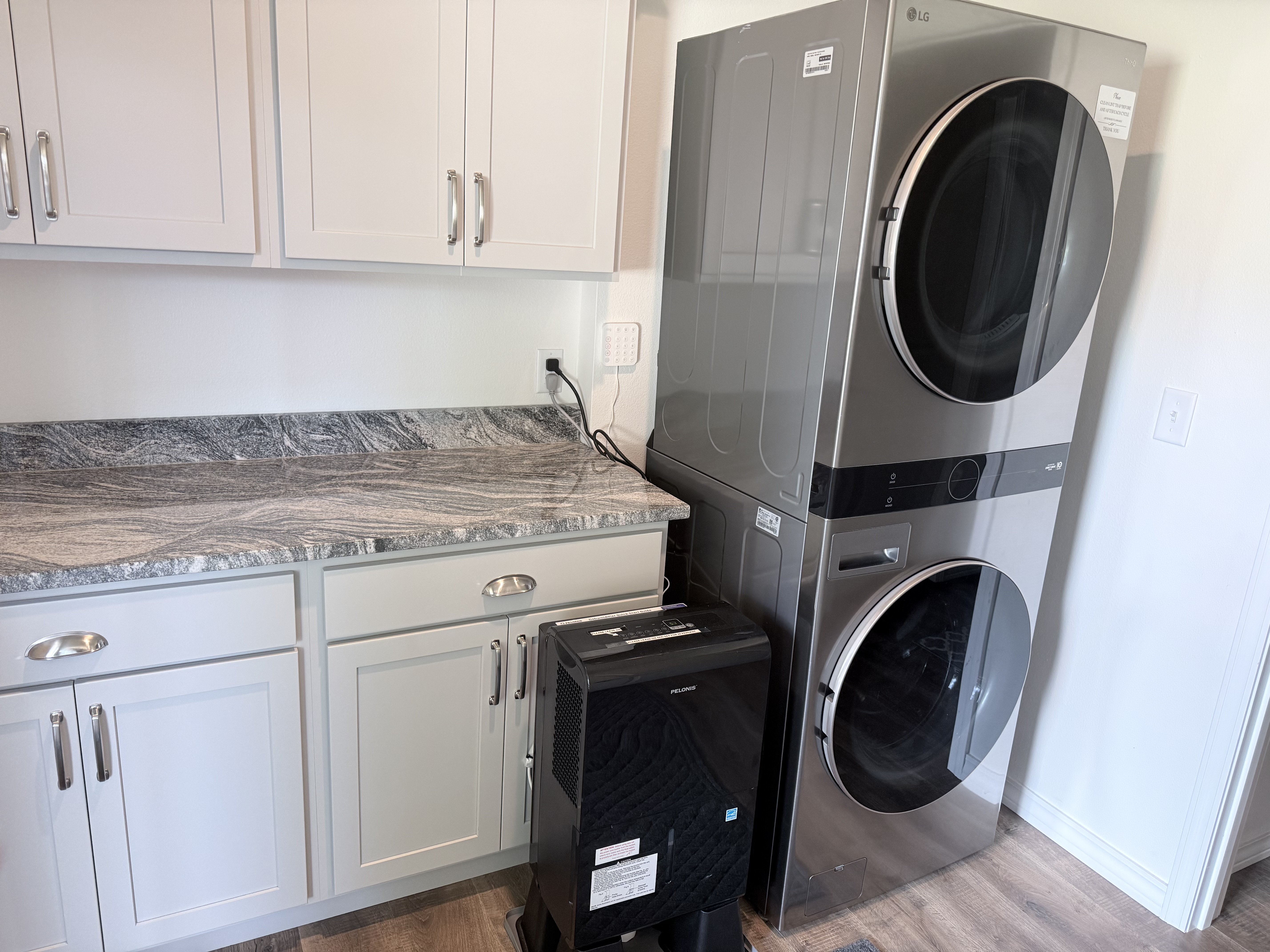 Full size laundry room with cabinets