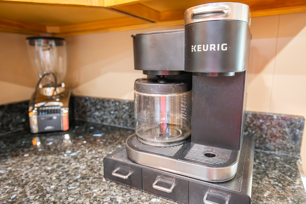 Start your morning right with a Keurig coffee maker and essentials provided.