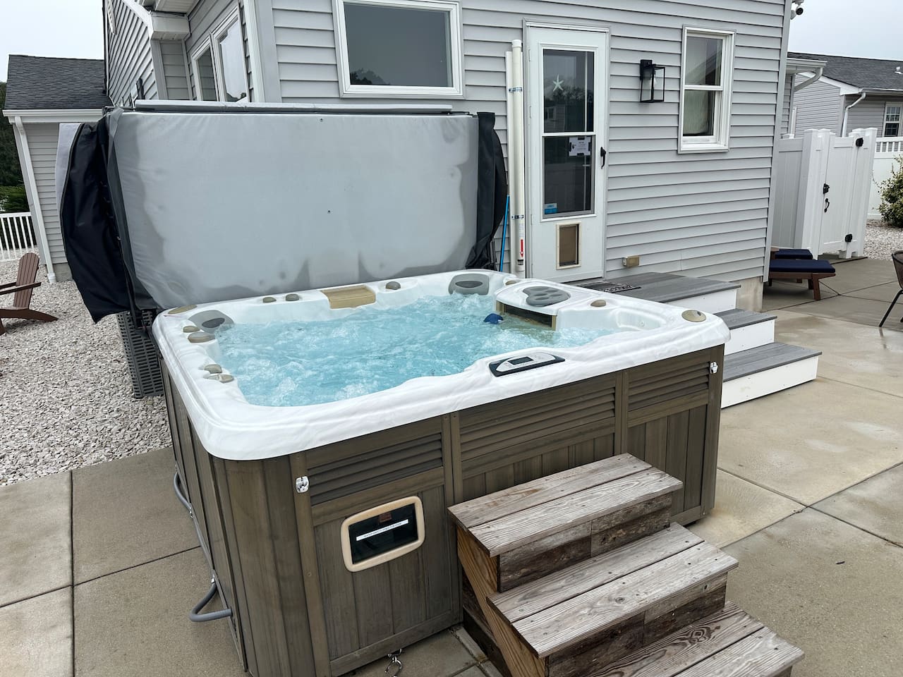 Unwind in this premium private hot tub, perfectly situated in the fenced backyard. With easy-access steps and multi-colored lighting, it offers the ultimate way to relax after a day at the beach.