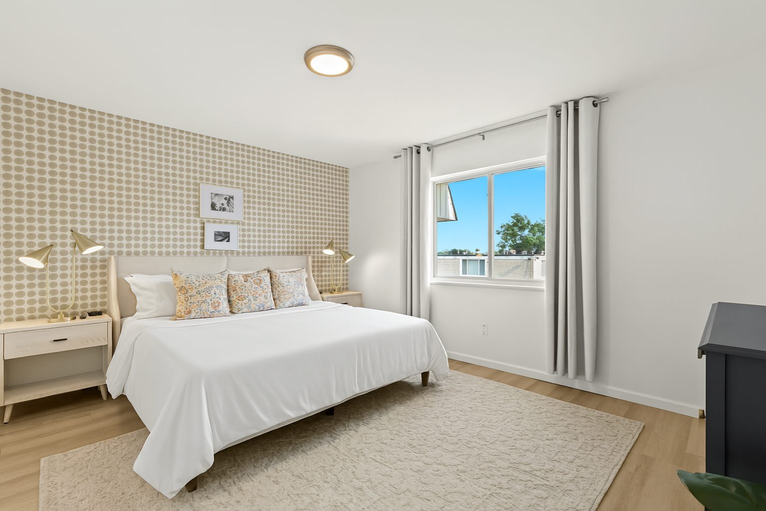 Bright and airy bedroom with blackout curtains, plush bedding, and a peaceful atmosphere.