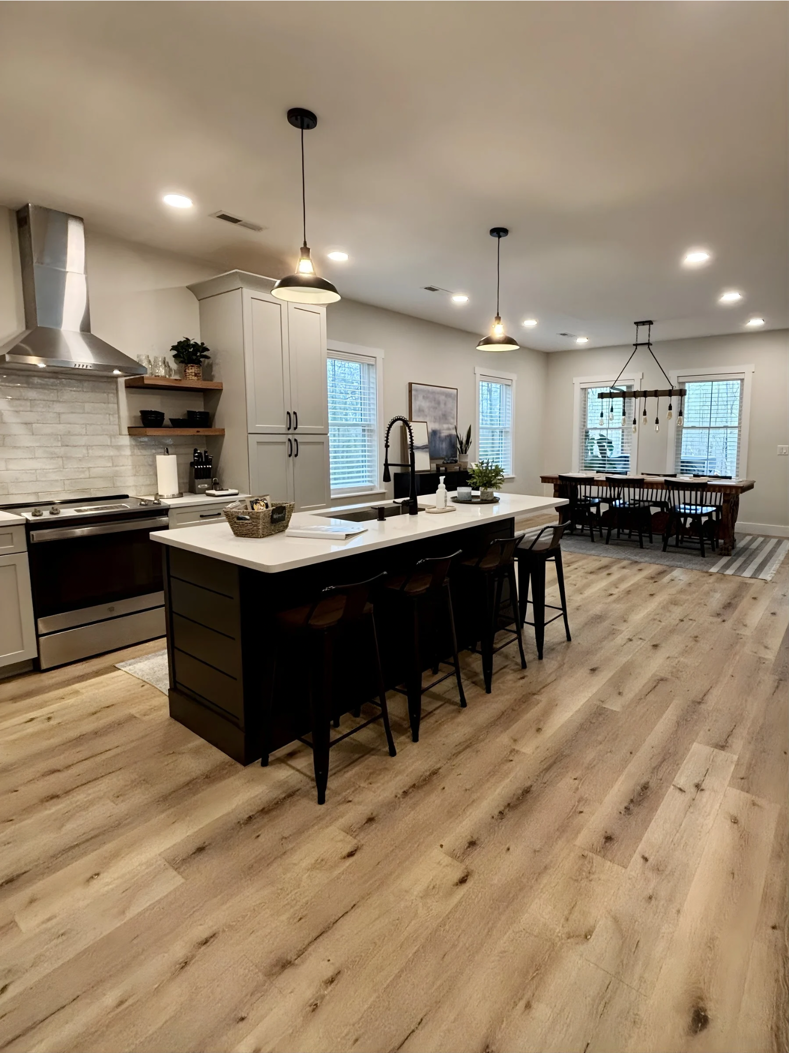 Experience culinary delight in our stunning open chef’s kitchen, complete with modern appliances, spacious island seating, and a warm, inviting atmosphere. 