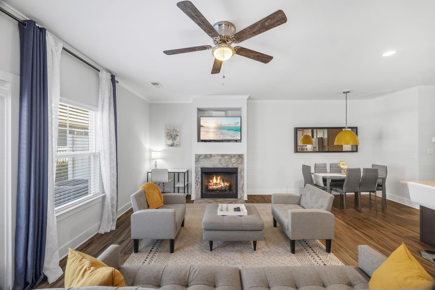 Spacious layout seamlessly connects the living room, dining area, and kitchen, ideal for families and groups.