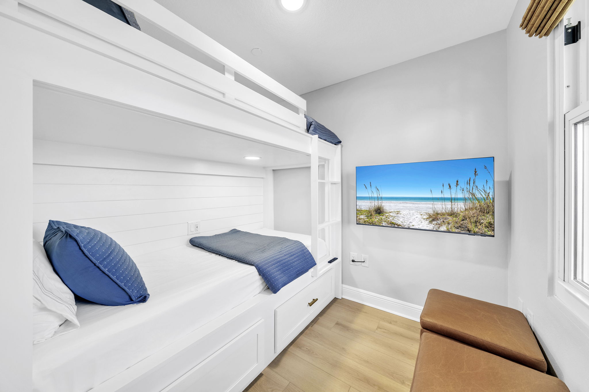 Built-in bunks with outlets, reading lights, and storage drawers underneath for clothes make this space both fun and functional. 