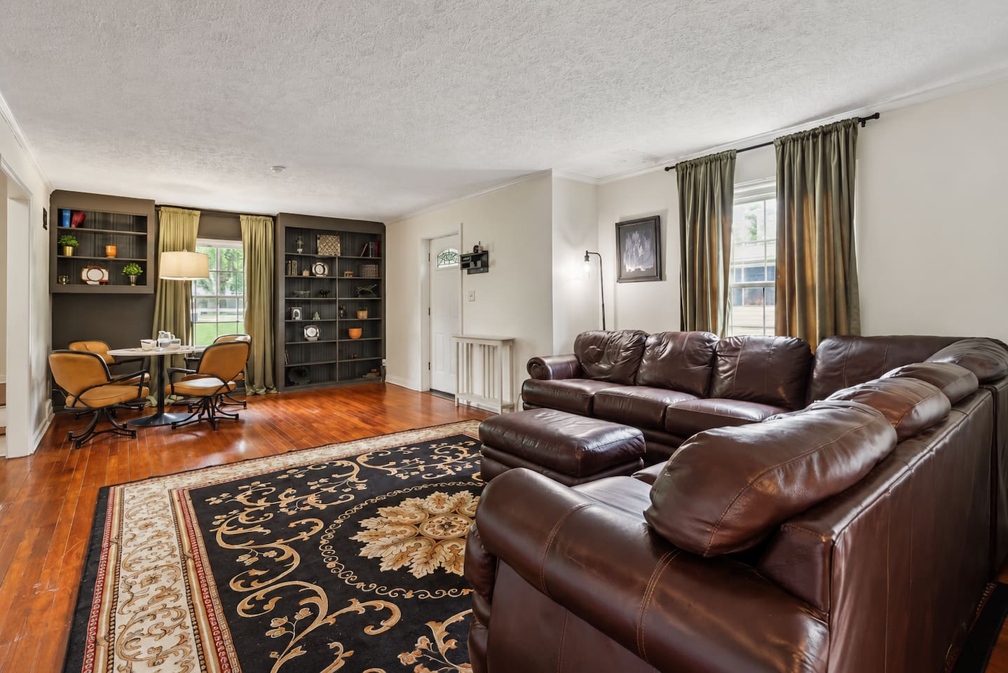 Settle into the spacious living room with plush seating, warm wood floors, and plenty of room for everyone to relax together.
