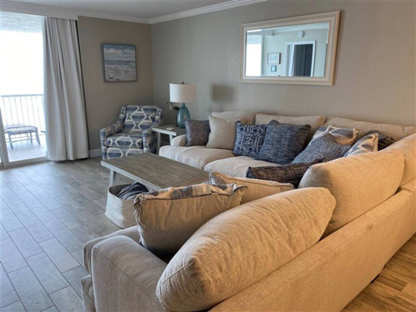 Living room slider opens to balcony and ocean view