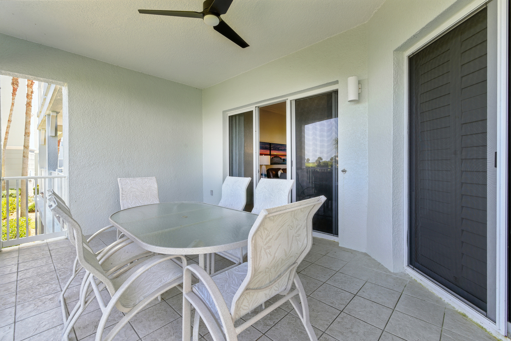 🌿☀️ Your private, covered balcony is the perfect spot to sip coffee in the morning or enjoy a sunset drink—complete with a dining table, ceiling fan breeze, and peaceful views just outside the living room. 🍹🌅
