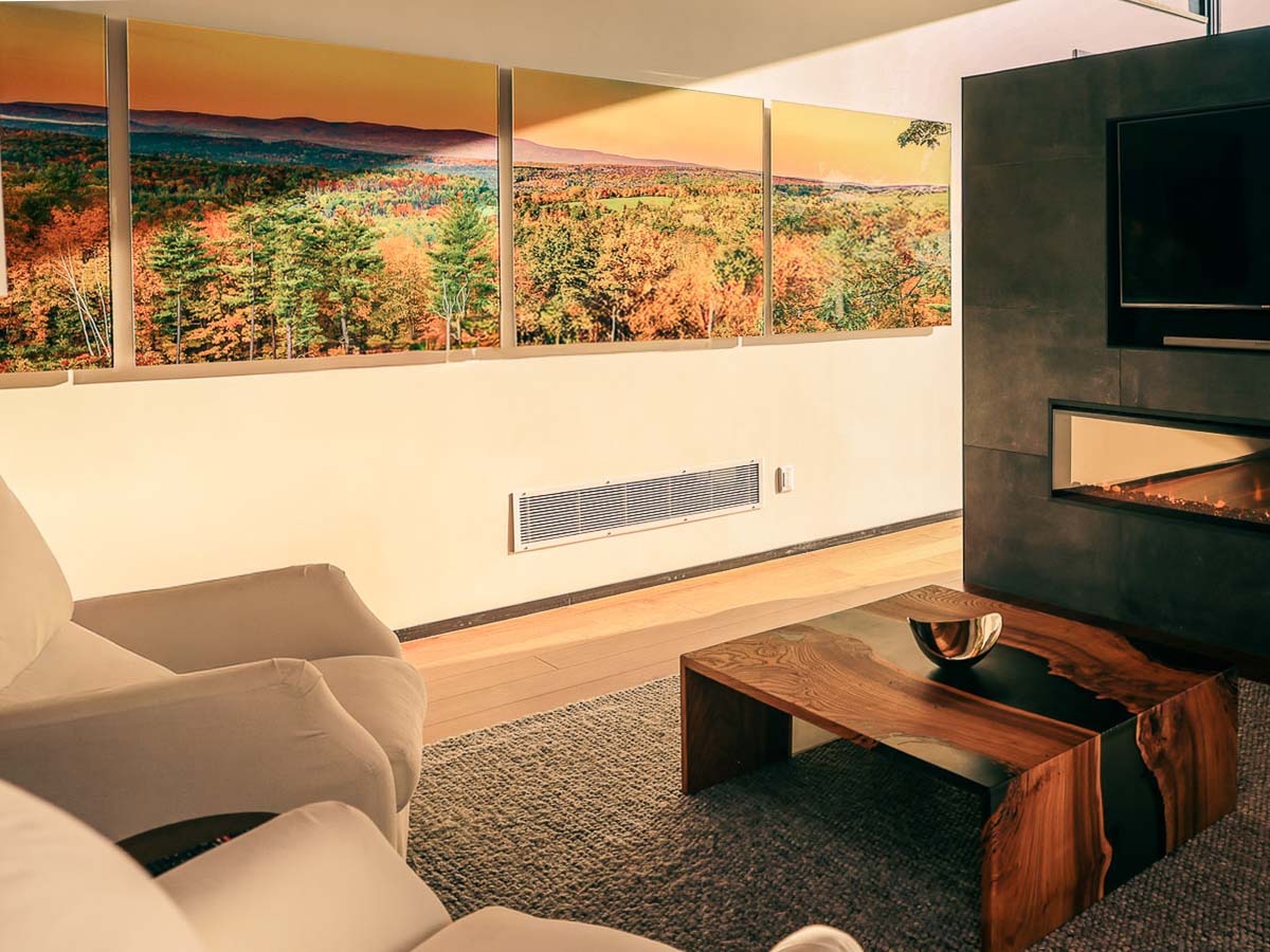 Primary Suite sitting area with linear fireplace lit at evening &mdash; Sunset Falls