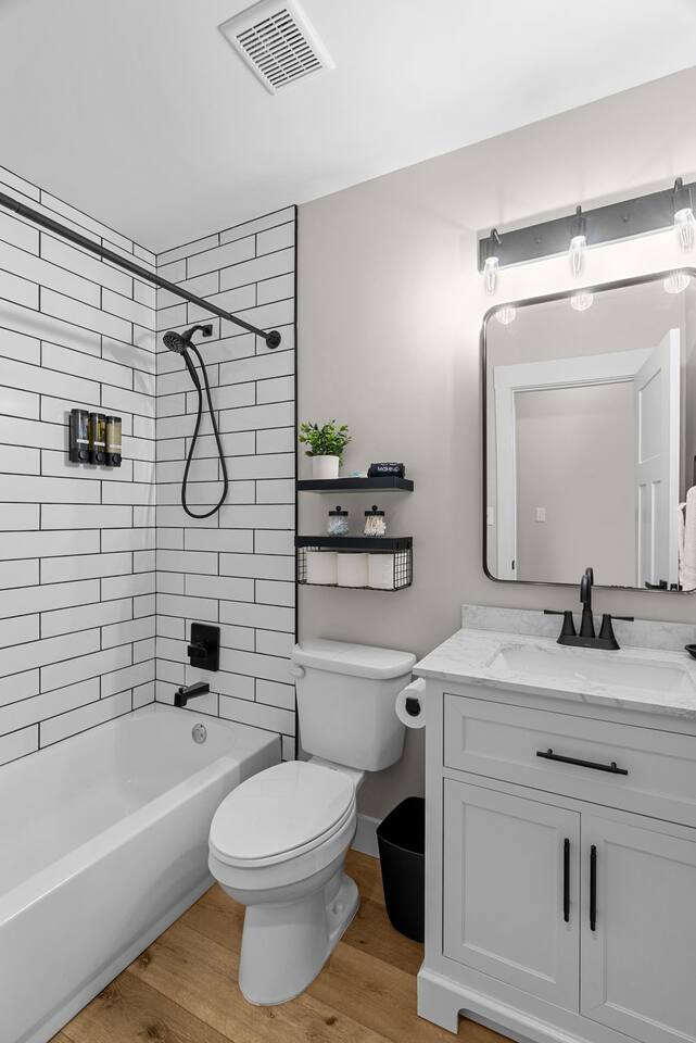 Second floor shared bathroom with shower over tub. Shampoo, conditioner, body wash, hand soaps and hair dryer available for your use.