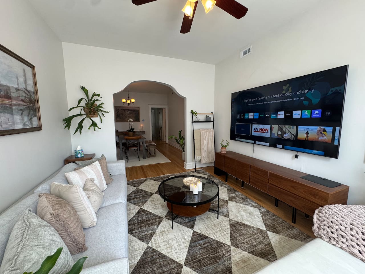 Spacious living room with smart TV, comfortable seating, and stylish decor for rlaxing after exploring Chicago.