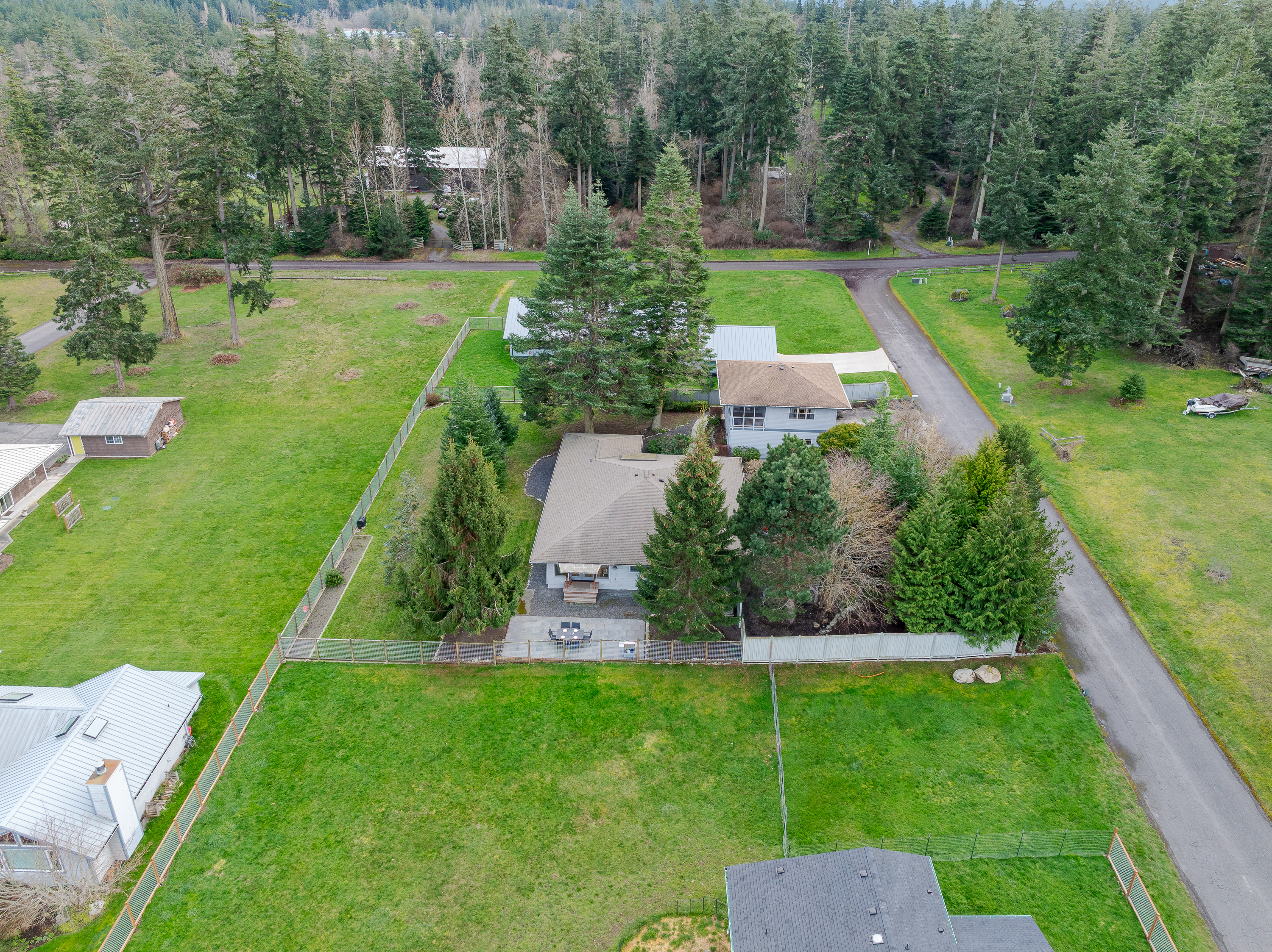 Luxury meets nature on this expansive estate set on emerald lawns and framed by majestic evergreens.