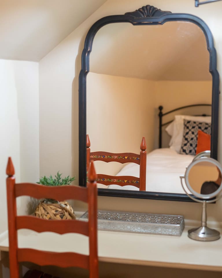 Get settled in with ease. This room offers a charming vanity and desk setup along with a large closet, ensuring you have plenty of room to unpack and stay organized during your visit.