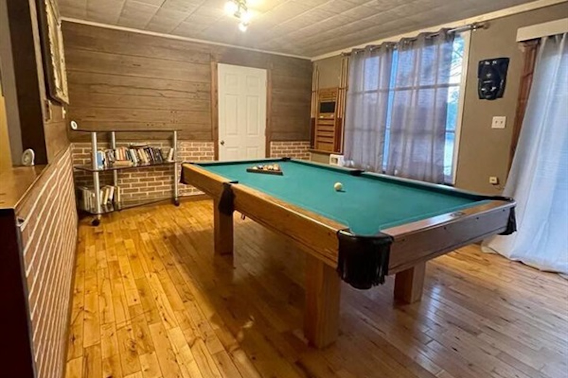 Spacious recreation room with pool table