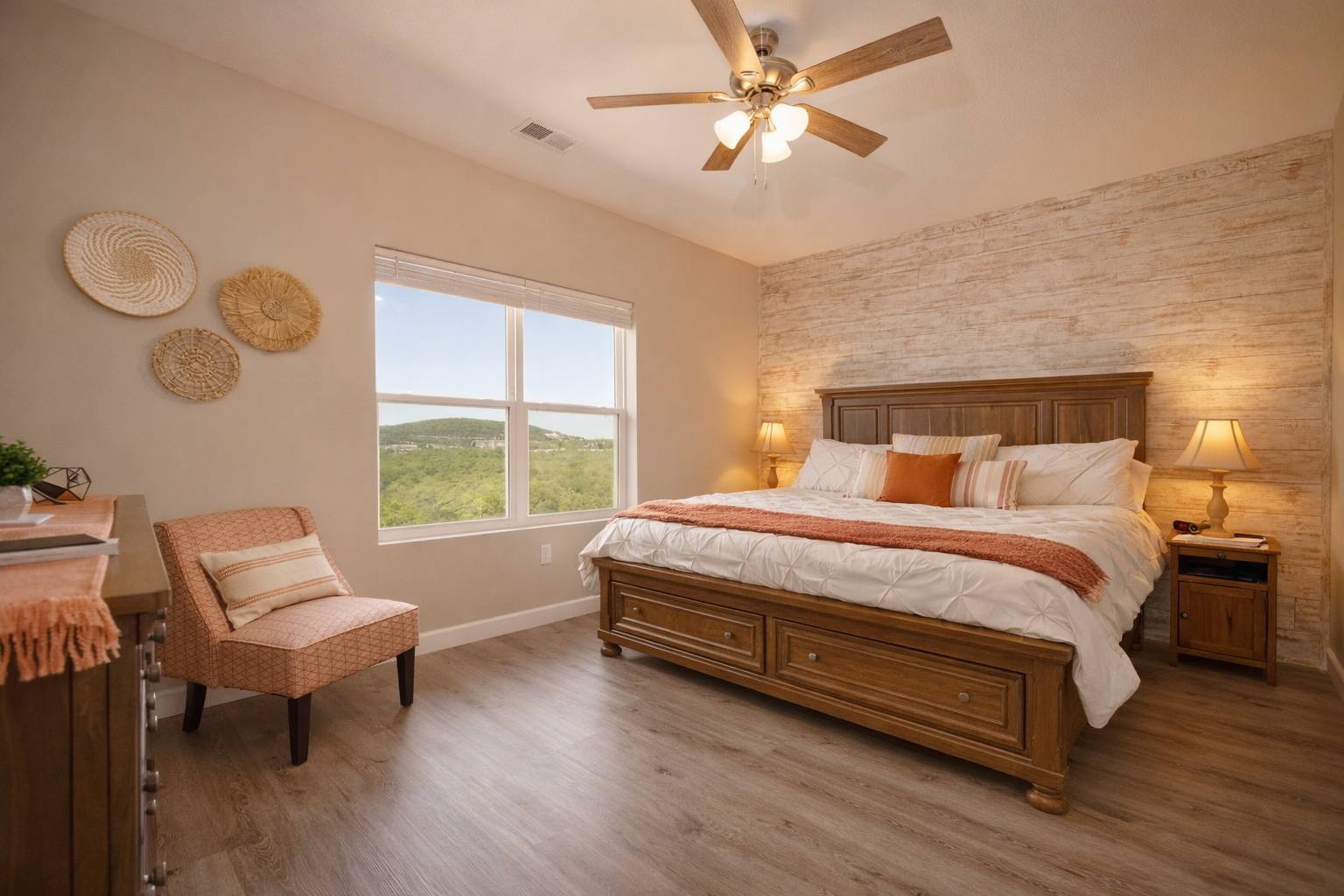 Bright and spacious king bedroom with cozy layered bedding and beautiful hill views
