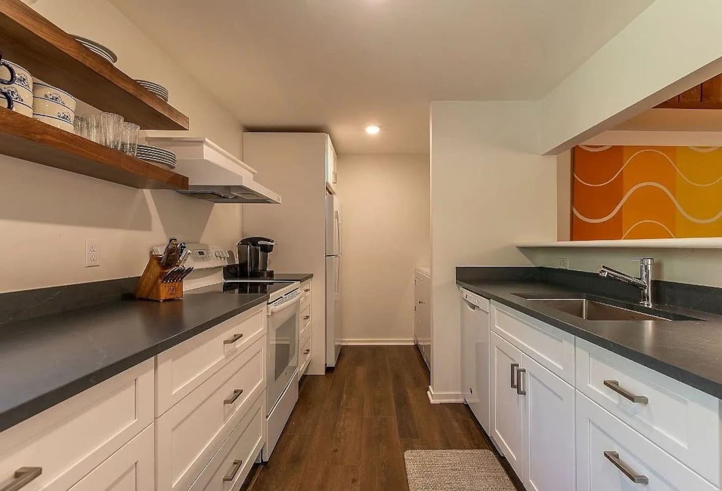 Modern kitchen: Sleek countertops, open-shelving, and all the tools needed for your culinary adventures.