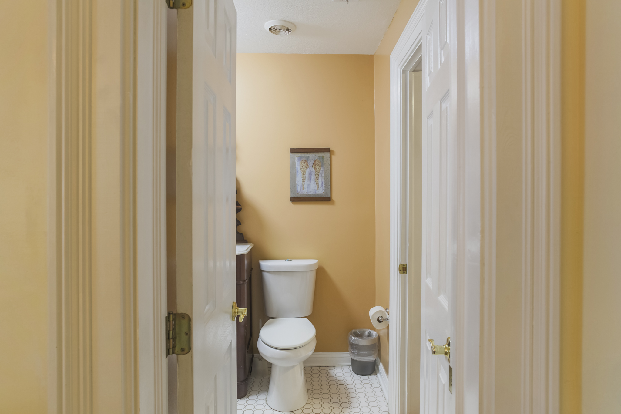 This ensuite bath conveniently connects the king bedroom and dining room, offering easy access from both spaces.