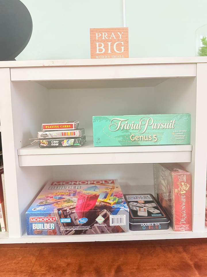 A full shelf of classic board games and activities — perfect for family nights or rainy day fun.