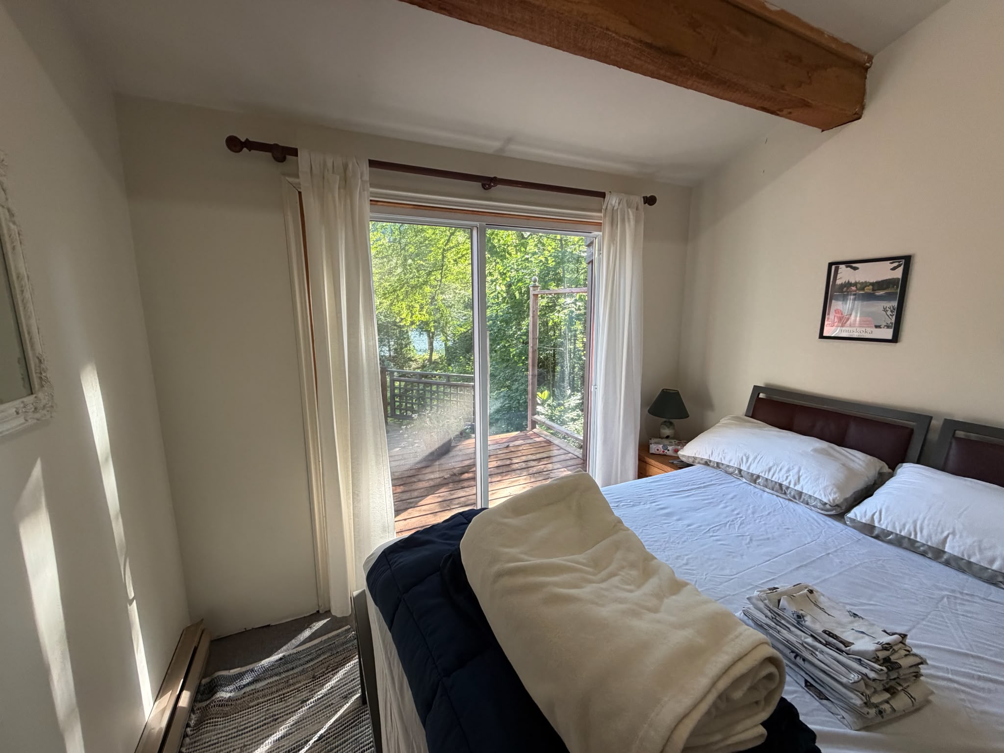 Bedroom C with sliding door out to seating on adjacent deck