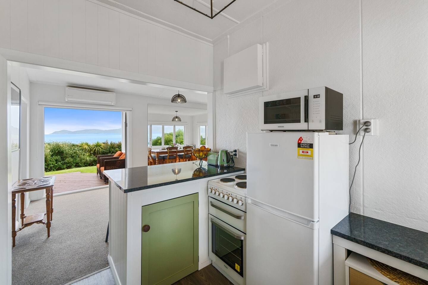 Awesome view while cooking dinner.  Quaint, Kiwiana, bach kitchen that has been lovingly modernised.