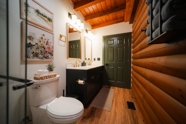 Full bathroom blending modern finishes with warm, rustic cabin charm.