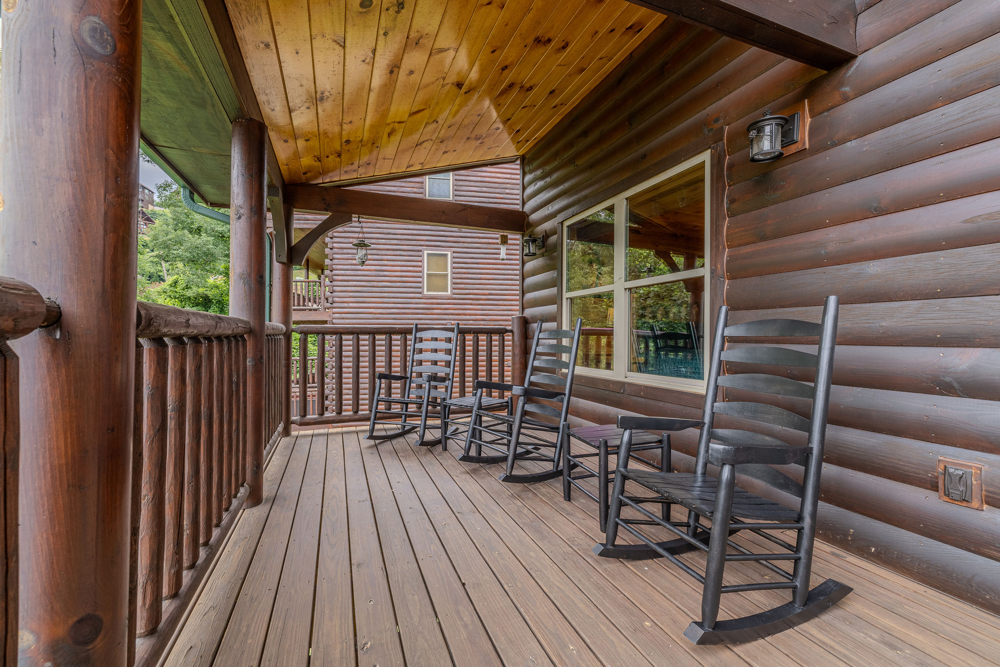 The Skyline Deck offers covered outdoor seating for morning coffee, evening drinks, and peaceful Smoky Mountain views.