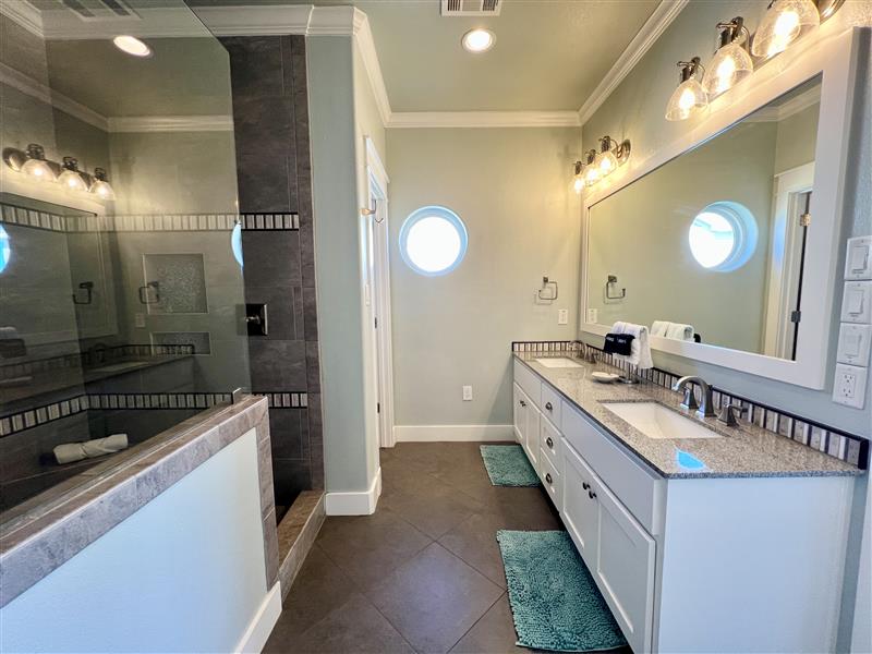 Crystal Paradise Bathroom 4: Our bathrooms include contemporary vanities with quartz countertops, elegant fixtures, and oversized mirrors, offering both function and style.