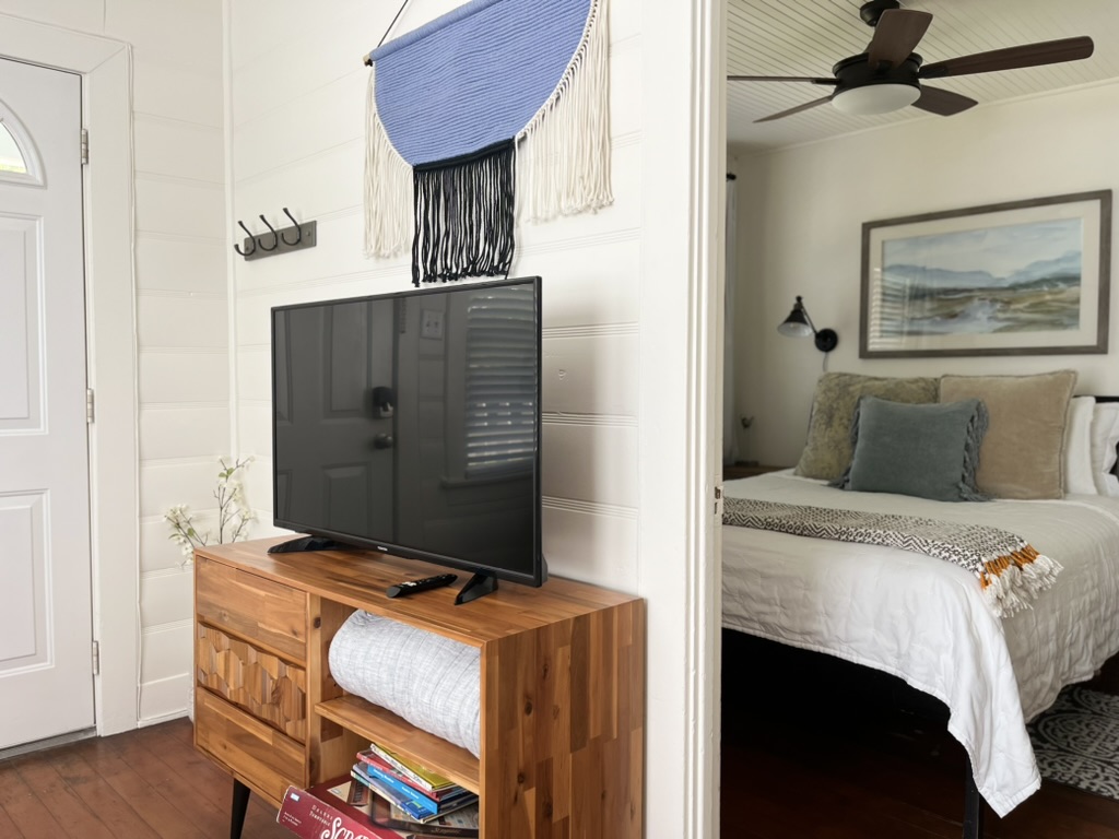 1bed/1bath living room with new media cabinet with sleeper sofa linens