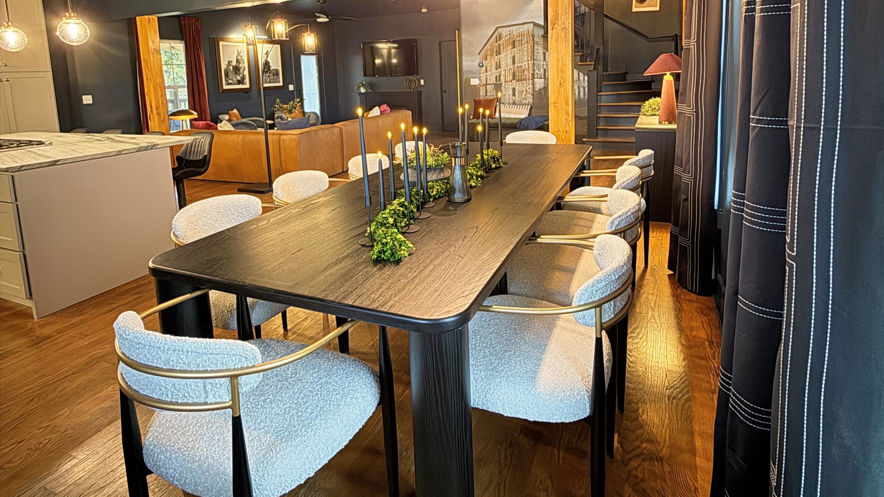 Where form meets warmth — an open-concept design connects kitchen, dining, and living spaces in perfect harmony, wrapped in rich wood tones, soft lighting, and refined textures that define The Rickhouse Retreat’s modern bourbon-country style.