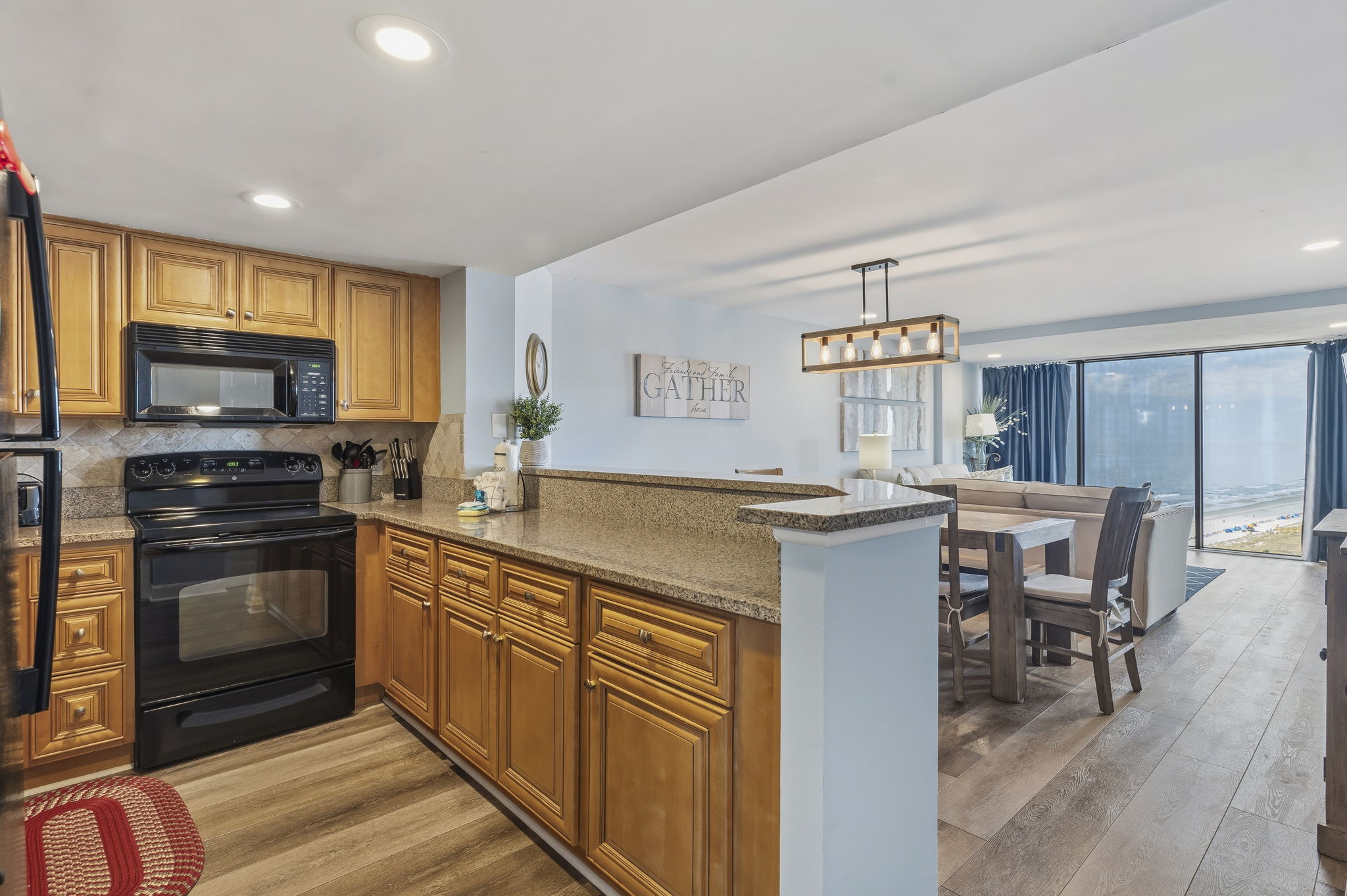 Kitchen with granite countertops opening to the dining area