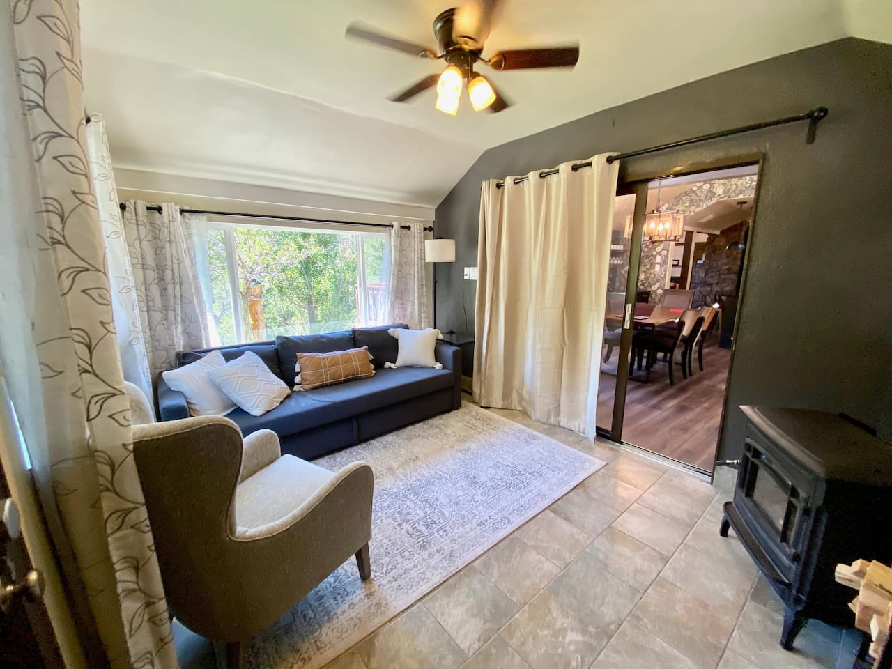 Sunroom located off the front door.  The couch folds out to a queen size bed.  Close the doors and curtains for complete sleeping privacy. The wood stove in the winter will keep you warm and cozy!