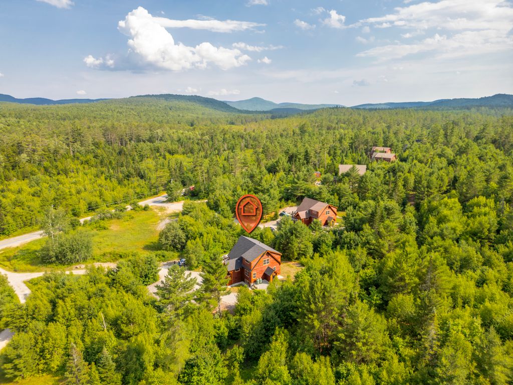A cozy community where neighbors wave from winding driveways and forest trails!