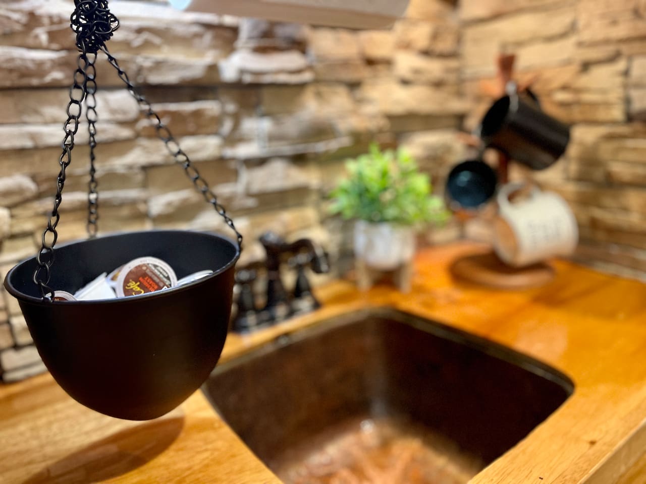 Hammered copper sink and stone adds to the rustic charm. 