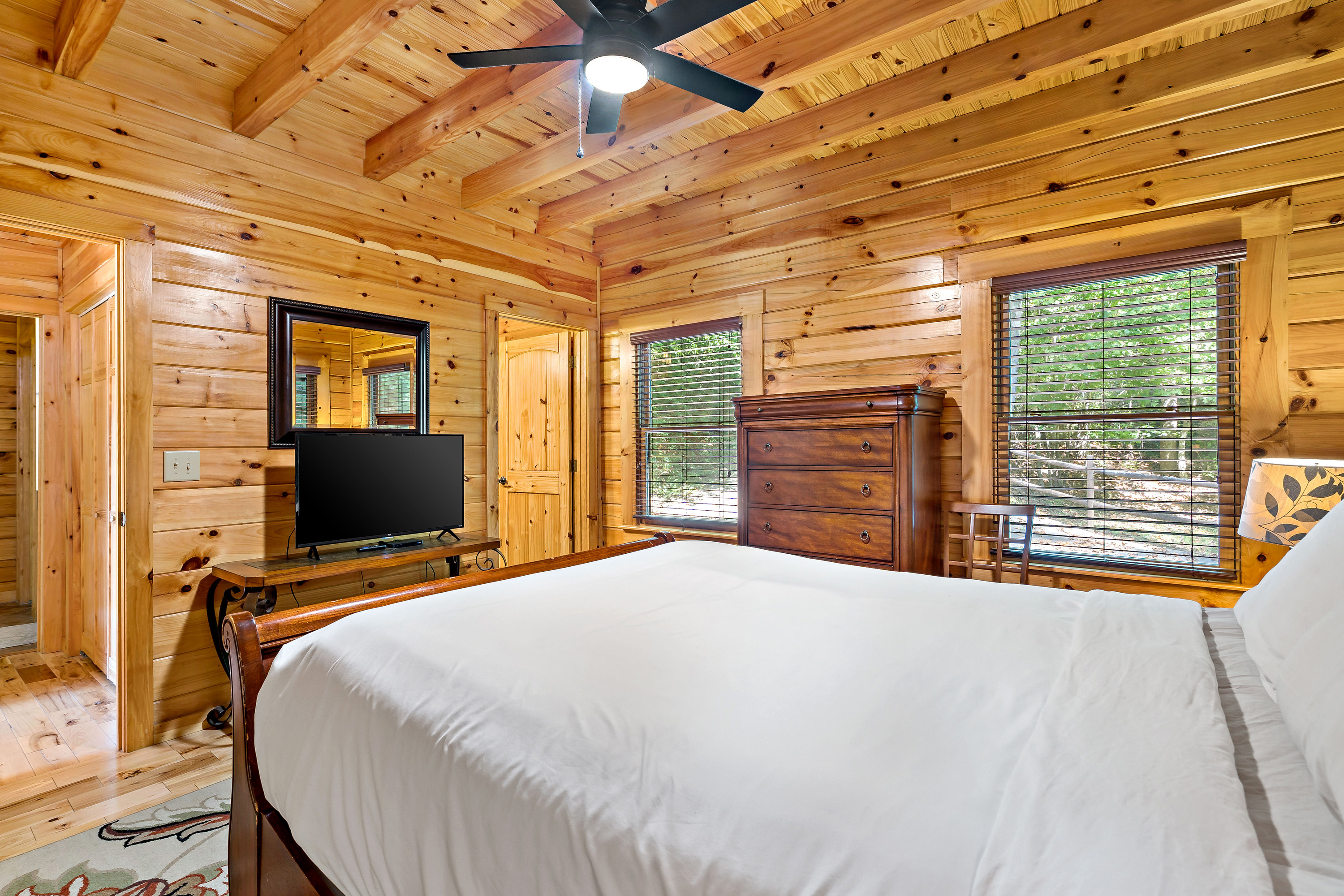 The master bedroom has a TV and a dresser